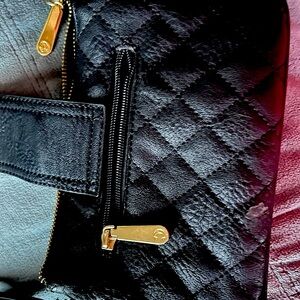 Small black purse 8x5 with gold trim and zippers